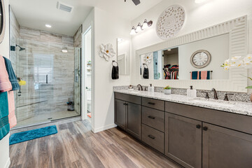 A spacious bathroom featuring two sinks and a luxurious walkin shower