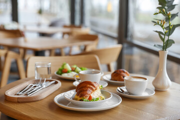 Delicious breakfast served on wooden table in cafe