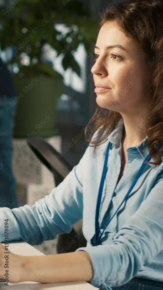 Poster vertical video employee at office desk typing on keyboard, editing documents on computer. worker inp