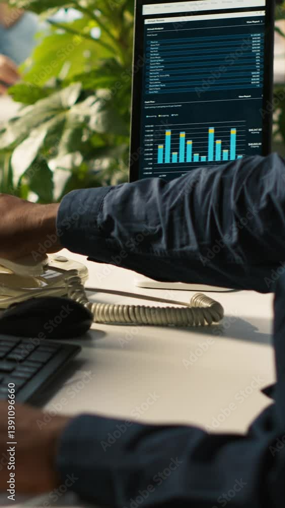 Poster vertical video close up of worker in office using landline phone to talk with customer. african amer