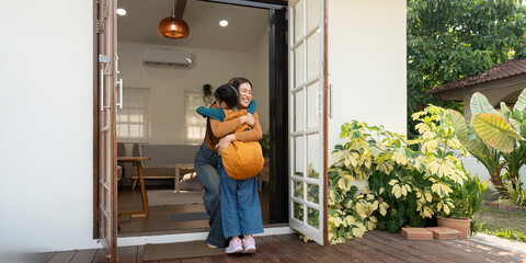 Back to School and Mother-Daughter Bonding. A joyful reunion as a mother hugs her daughter after coming home from school.