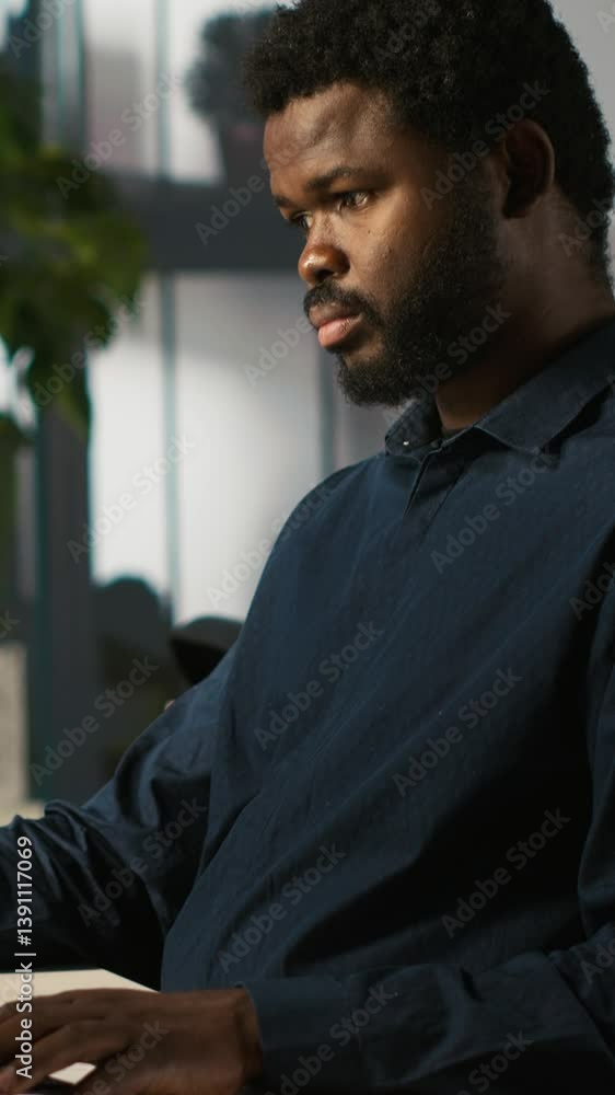 Poster vertical video accountant in modern office using mobile phone to text friends after inputting data o