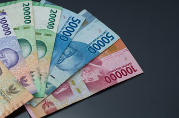 Assorted Indonesian Rupiah Banknotes on a Dark Background