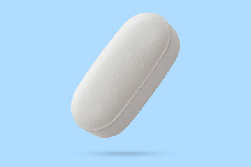White medicine pill tablet float on blue background