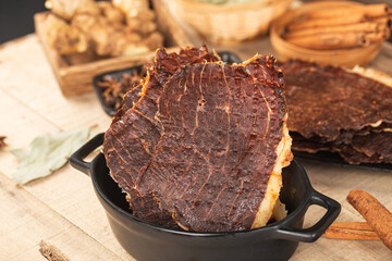 Dried beef crisps, beef crisps on a wooden background
