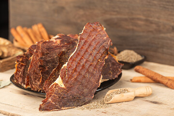 Dried beef crisps, beef crisps on a wooden background