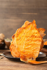 Brown dried chicken breast jerky meat texture close up