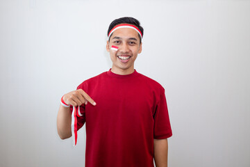 Happy Young Man Pointing Down With A Cheerful Look, Representing Indonesian Pride And Unity On Independence Celebration.