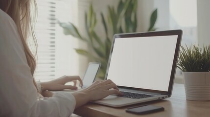 Fototapeta premium Woman Working on Laptop with Blank Screen at Home Office