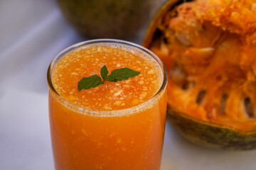 Ayurveda fruit juice of Bel fruit or wooden apple called Bel Ka Sharbat with mint leaf of Bel on a jute background. natural detox. vitamins for immunity.
