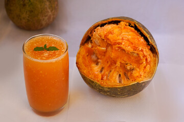 Ayurveda fruit juice of Bel fruit or wooden apple called Bel Ka Sharbat with mint leaf of Bel on a jute background. natural detox. vitamins for immunity.