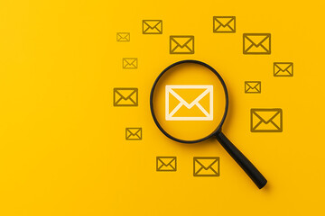 Magnifying glass focusing on envelope email icon over yellow background, digital communication search concept, message tracking and inbox analysis symbol, targeted email discovery illustration, online