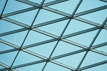 Fototapeta premium Modern glass structure creates a striking pattern against the sky