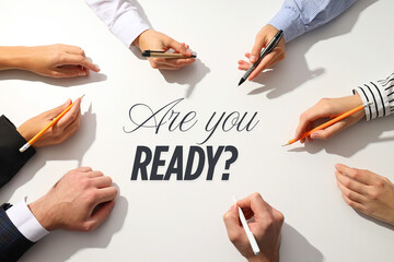 Job interview, Participants gather around a table, showing readiness to tackle job interview preparation with pens and determination to succeed