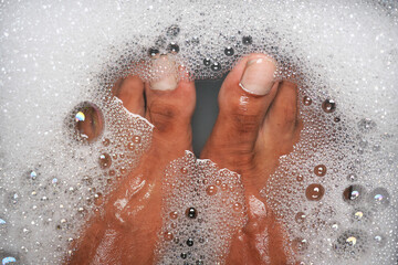 Relaxing moment in warm bubble bath with clean feet