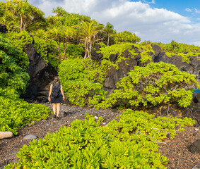 Female Hiker on Volcanic Shoreline of The Kings Trail Near Kauiau Point, Waianapanapa State Park,...