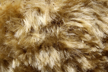 Light brown shaggy plush faux fur material fabric textured background