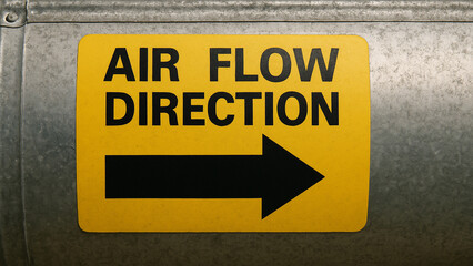 Air flow direction sign on duct indicates engineering specifications for proper air circulation