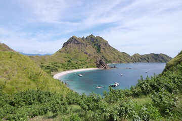 A breathtaking view of Labuan Bajo with turquoise waters, green islands, and vibrant coastal charm...