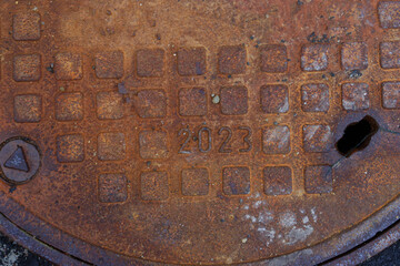 A close-up of a fragment of a rusty metal hatch.