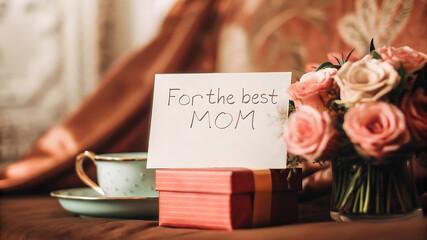 Pastel Mother's Day Scene with Teacup, Roses, and Gift Box