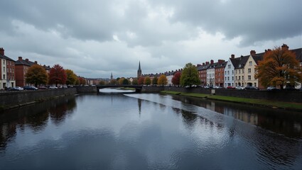 Naklejka premium Liffey Views in Ireland Dublin shows calm river with bridge, red-roofed houses, trees in autumn colors. Concept of Liffey Views in Ireland Dublin reflects serene landscape.
