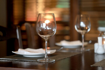 table setting in the restaurant, glasses and cutlery, a clean new table in the restaurant is waiting for guests, a free table
