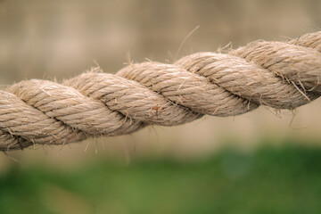 Closeup of a thick brown rope suitable for marine, nautical, outdoor, adventure, and rusticthemed designs, websites, posters, and advertising materials. © Willy Chan