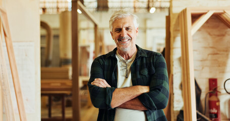 Workshop, man and carpenter in portrait for arms crossed, wood manufacturing and production business. Happiness, mature contractor and pride with furniture for service, maintenance and timber craft