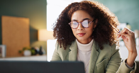Office, reading and woman with glasses, laptop and media coordinator with budget for ad campaign....