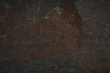 A textured stone background showcasing a brutal, monolithic rock formation with cracks and fragments. Perfect for design templates, banners, or projects highlighting natural power and beauty.