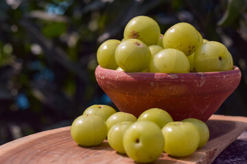 Fresh Indian Gooseberries or Amla in a clay bowl.
