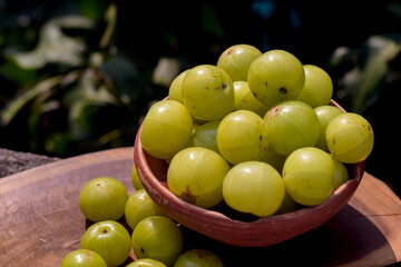Fresh Indian Gooseberries or Amla in a clay bowl.