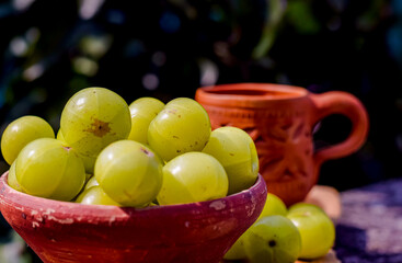 Fresh Indian Gooseberries or Amla in a clay bowl.