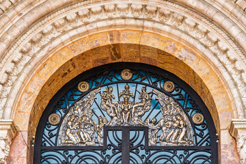 Obraz premium Ornamental bronze relief with religious motifs on the main entrance gate of the Cathedral of the Immaculate Conception in Cuenca, Ecuador, showcasing detailed colonial craftsmanship
