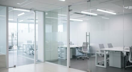 A bright office space with glass walls and white furniture in a modern and minimalist design style
