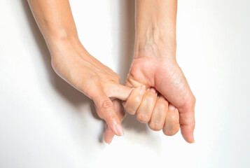 Woman hands holding each other, isolated on white background, closeup