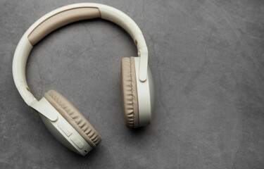 Wireless headphones resting on gray surface