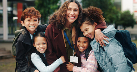 Fototapeta premium Children, hug and smile with teacher, school and support in city for solidarity, connection or portrait. Happy kids, group and woman with embrace, education and outdoor for reunion with scholarship