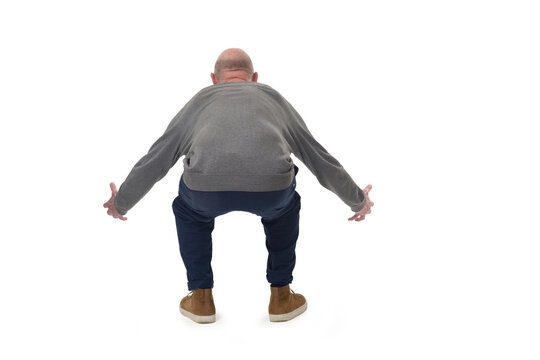 back view of a man lifting something heavy from the ground on white background - Powered by Adobe