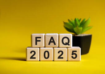 FAQ 2025 on wooden cubes text on a yellow background