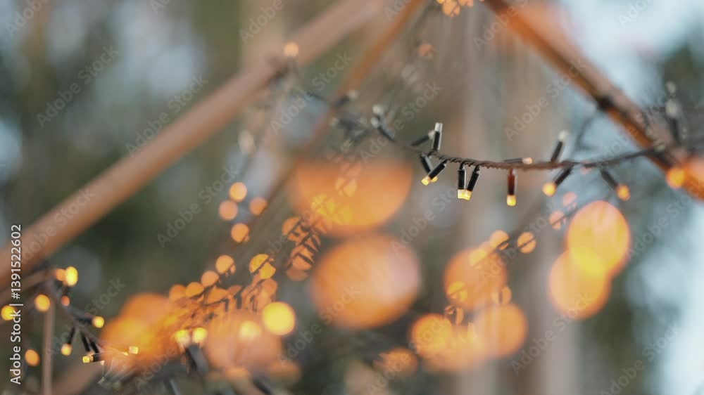 Poster defocused glowing string lights with warm orange bokeh in outdoor setting