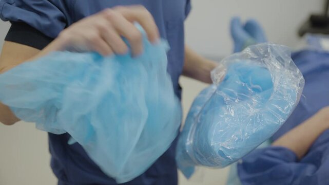 Footage showing hospital staff discarding clean or unused medical clothing and gloves, highlighting unnecessary waste in healthcare.