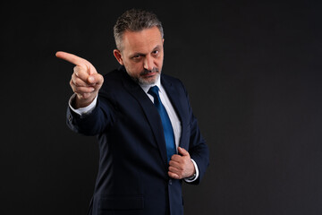 Stern businessman pointing to the side.