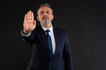 Businessman making stop gesture.