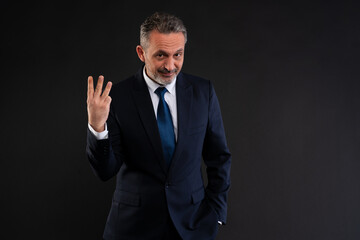 Businessman showing three fingers gesture.