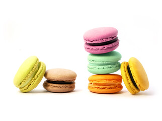 Pile of macaron cookies in various flavours and colours isolated on white background.