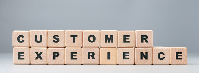 Customer Experience text by the alphabet wood cubes arranged in a row