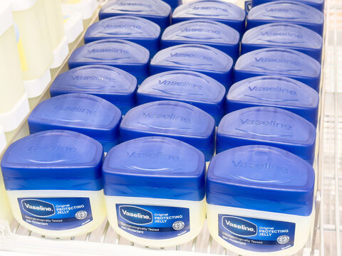 Vaseline jelly containers in blue caps on shelf