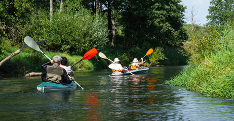 Group kayak trip for seigneur and senora. An elderly couple And adult rowing boat on the river, a water hike, a summer adventure. Age-related sports, mental youth and health, tourism, active old age